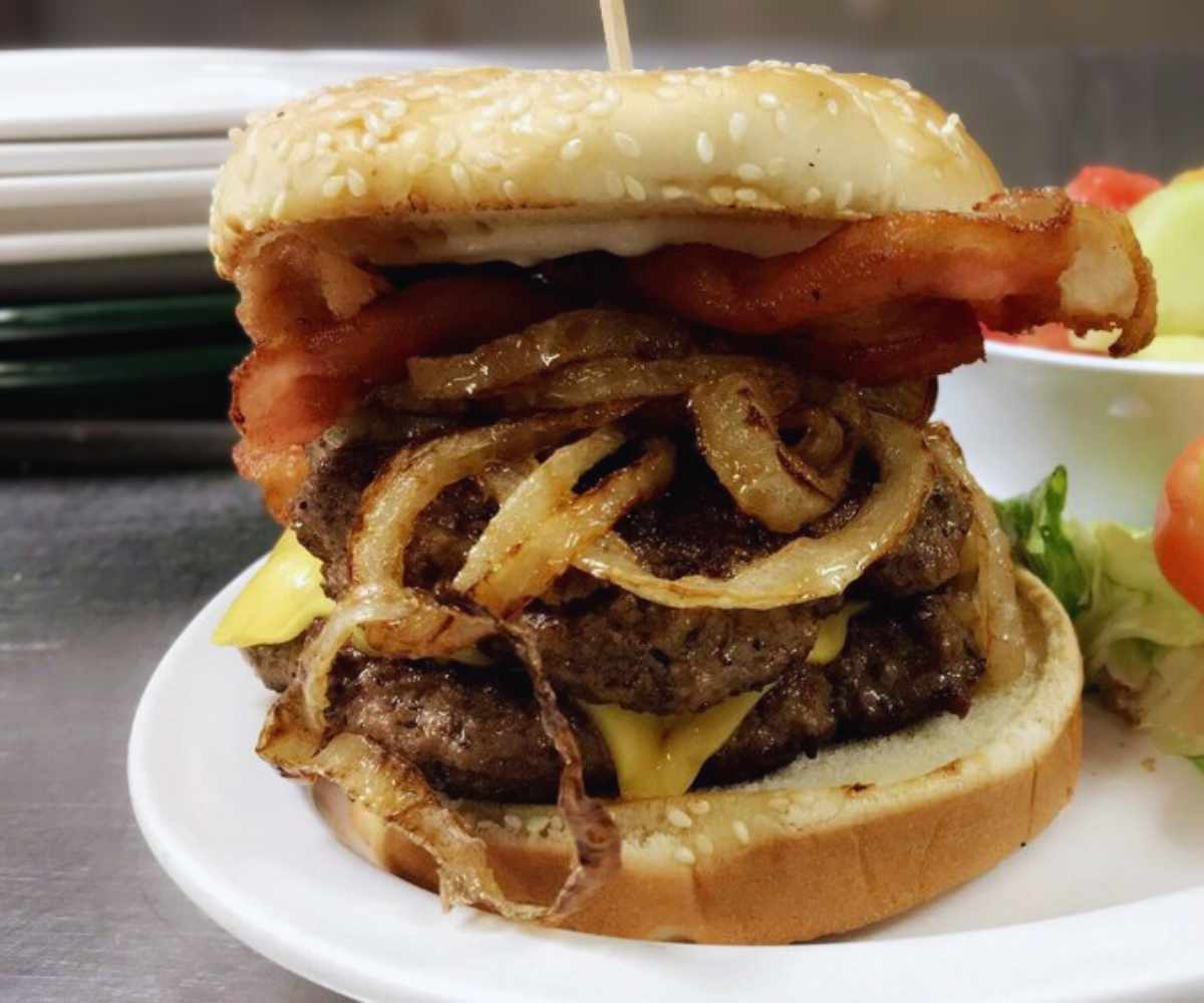 huge burger with onions at Irene's burger cafe in Palmdale, CA