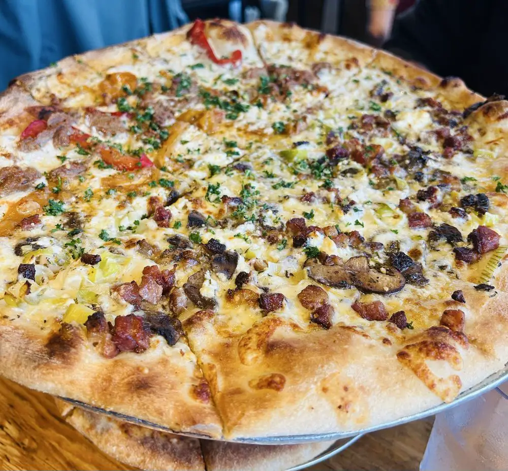 pizza pie with bacon, leeks