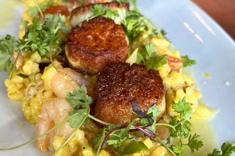 Seared Sea Scallops with Saffron Calasparra Rice at Revival Kitchen & Bar in Concord, New Hampshire